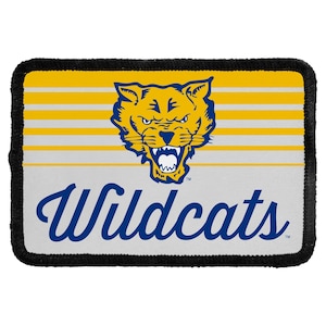 May include: A rectangular patch with a black stitched border featuring a yellow and white horizontal striped background. Centered is a blue and yellow wildcat head graphic with an open mouth. Below, the word Wildcats is written in blue script.