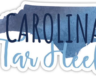 May include: A blue watercolor outline of the state of North Carolina with the text "CAROLINA Tar Heels" in black and blue lettering.