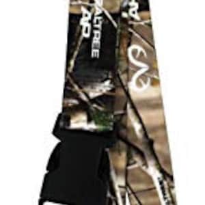 May include: A brown and tan camouflage lanyard with a black plastic clip and a silver metal ring. The lanyard has the words "RealTree AP" printed on it.
