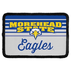 May include: A rectangular patch with a black stitched border featuring the text MOREHEAD STATE in yellow block letters above a blue and white eagle head graphic. Below the eagle, the word Eagles is printed in a blue cursive script font.