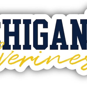 May include: A sticker with the words "MICHIGAN Wolverines" in navy blue and yellow script. The sticker features a floral design with yellow flowers and green leaves. The sticker has a white border.