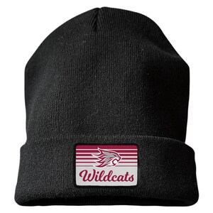 May include: A black knit beanie featuring a rectangular patch on the front cuff. The patch displays a maroon and white graphic of a wildcat head above the word Wildcats in a maroon script font, set against a background of horizontal stripes.