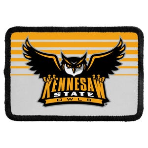 May include: A rectangular patch with a black stitched border featuring the Kennesaw State Owls logo. The design includes a stylized black owl with yellow accents, the text Kennesaw State Owls, and a background of horizontal yellow and white stripes.