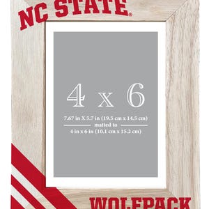 May include: Wooden photo frame with the text "NC STATE" at the top and "WOLFPACK" at the bottom in red. The frame is designed for a 4 x 6 inch photo, with the overall frame dimensions of 7.67 x 5.7 inches (19.5 cm x 14.5 cm).