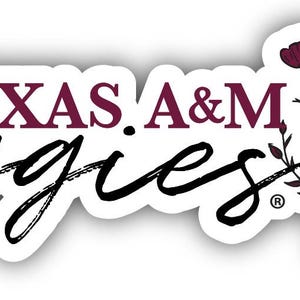 May include: A white sticker with the words "TEXAS A&M Aggies" in maroon and black script. The sticker features a floral design with maroon flowers and green stems.