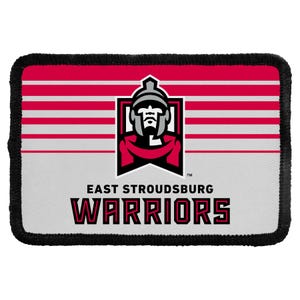 May include: A rectangular patch with a black stitched border featuring a red and white horizontal striped background. The center displays a grey warrior mascot logo above the black text EAST STROUDSBURG WARRIORS in a bold, block font.