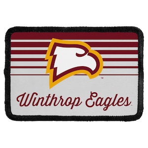 May include: A rectangular embroidered patch featuring the Winthrop Eagles logo. The design includes a stylized eagle head in white, gold, and maroon, set against horizontal maroon and white stripes, with the text Winthrop Eagles in maroon script.