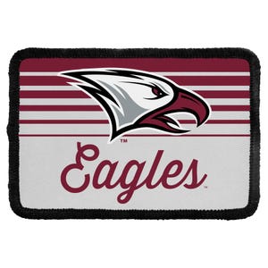 May include: A rectangular patch with a black stitched border featuring a maroon and white striped background. The design includes a stylized eagle head graphic in white, grey, and maroon, with the word Eagles written in maroon script below it.