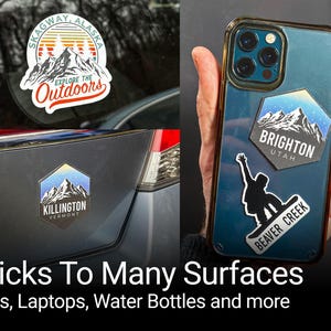 a person holding up a phone case with stickers on it