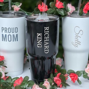 three personalized tumblers sitting on top of a table