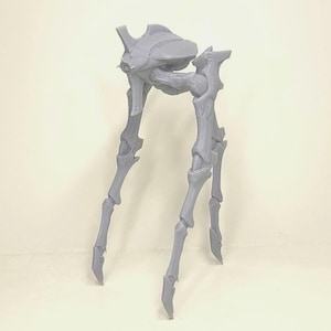 May include: A light gray, 3D-printed model of a futuristic, insect-like creature. The model features a segmented body and multiple articulated legs, suggesting a mechanical or robotic design. The creature's form is detailed and stylized.