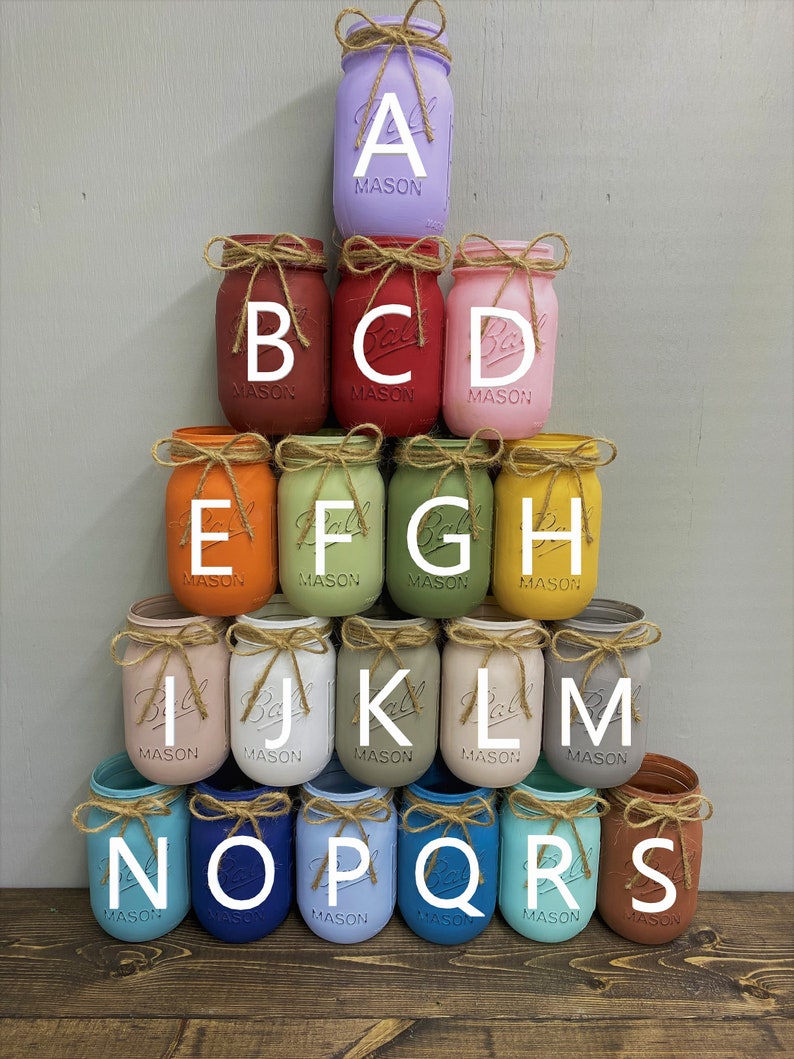 May include: A set of 15 mason jars painted in various colours, arranged in a pyramid shape. The jars are labelled with the letters A through S.