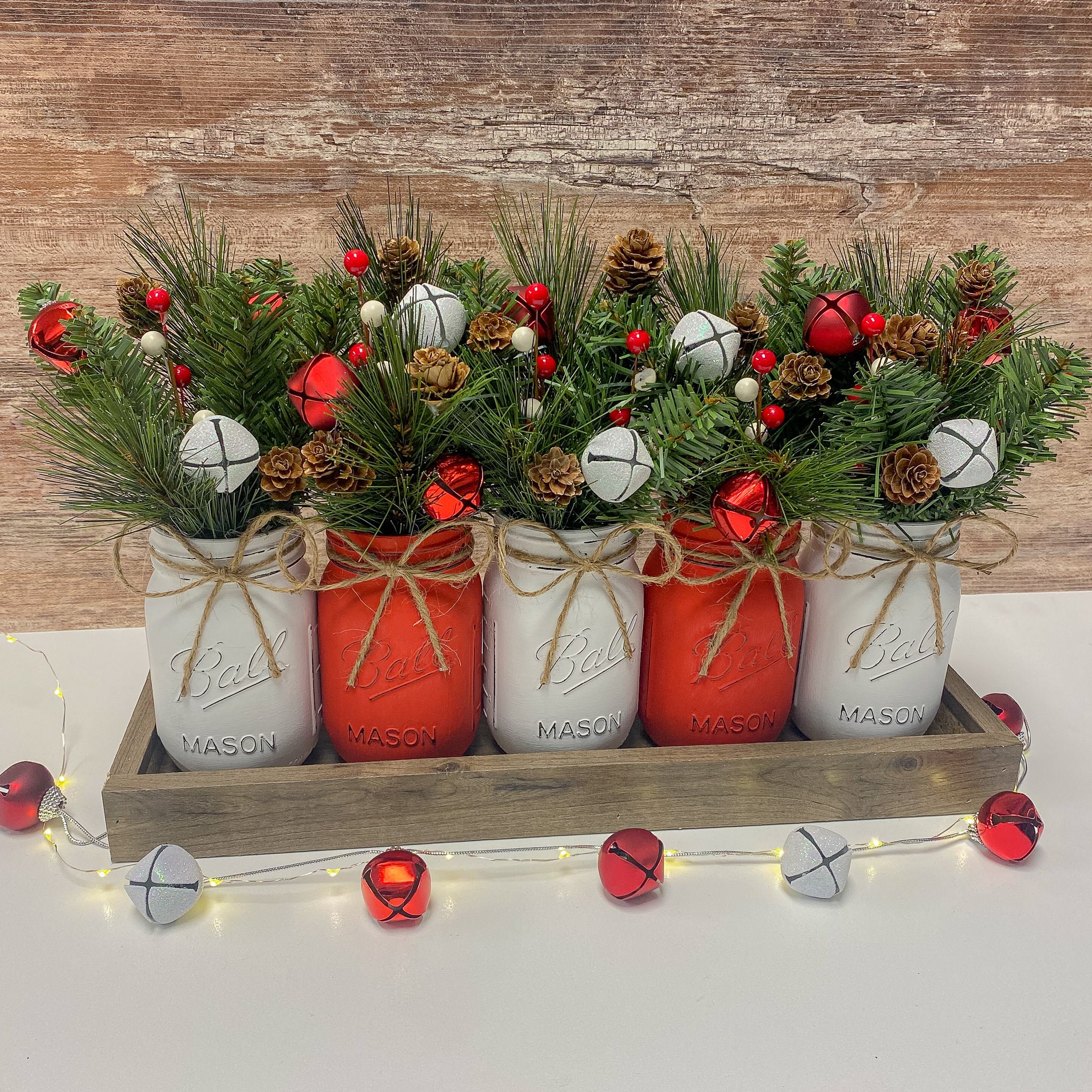 22 Christmas Table Centerpieces for a Festive Feast 2 Mason Jar Christmas Centerpiece: Winter Greens, Berries, Pinecones
