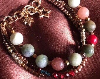 May include: Multi-strand bracelet with green, brown, red, and pink beads, gold accents, and a star charm.