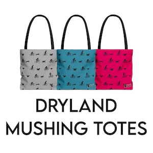 May include: Three tote bags with black handles. The bags are grey, teal, and pink, each featuring a repeating black graphic of a person on a bicycle, a person walking a dog, and a dog running. The text "DRYLAND MUSHING TOTES" is below the bags.