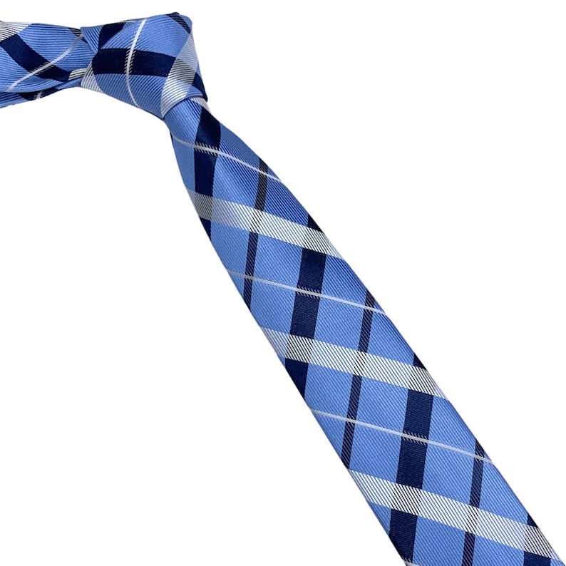 White and dark blue diagonal striped plaid tie on blue background 2.36 6cm