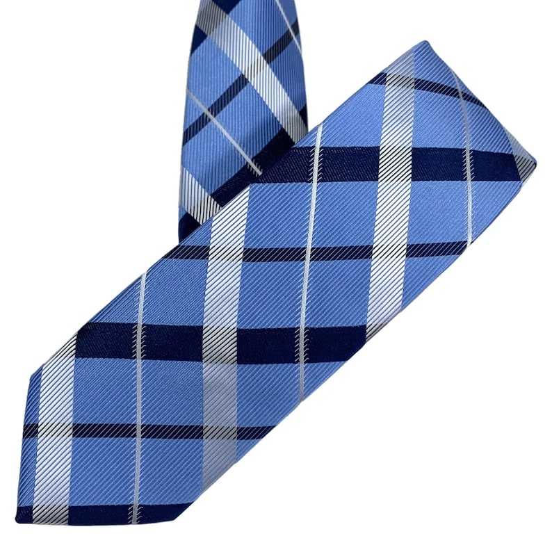 White and dark blue diagonal striped plaid tie on blue background 2.36 6cm