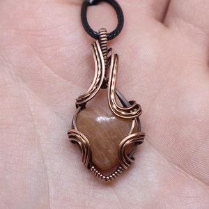 Sparkly peach moonstone heart pendant in oxidized pure copper