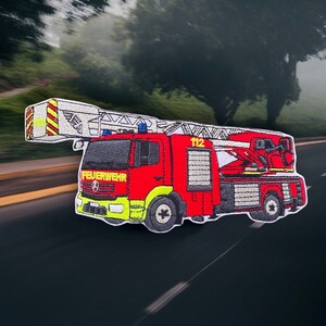 May include: Red and white embroidered patch of a fire engine with a ladder, the words "FEUERWEHR" and "112" are visible on the engine.