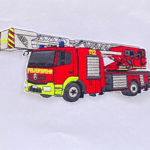 May include: Red and white embroidered patch of a fire engine with a ladder, the words "FEUERWEHR" and "112" are visible on the engine.