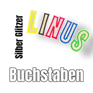 Könnte beinhalten: Silberne Glitzerbuchstaben, die den Namen "LINUS" in verschiedenen Farben buchstabieren. Die Buchstaben befinden sich auf einem weißen Hintergrund. Der Text "Silber Glitzer Buchstaben" ist in Schwarz auf der linken Seite des Bildes geschrieben.
