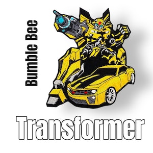 Könnte beinhalten: Gelber und schwarzer gestickter Aufnäher von Bumblebee, einem Transformer-Roboter, der sich in ein gelbes Camaro-Auto verwandelt. Der Aufnäher trägt den Text "Bumblebee" und "Transformer".