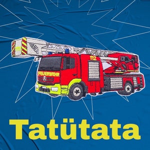May include: A red and white fire engine with a ladder, the words "Feuerwehr" and "112" on the side, and the word "Tat&uuml;tata" in yellow letters below the engine.