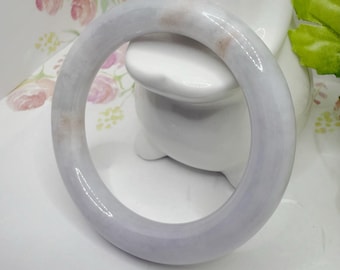 May include: A lavender jade bangle bracelet with a smooth, polished finish.