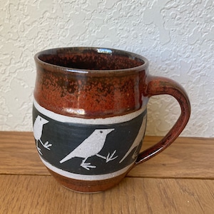 Marching ravens, black, white and rust red, folk art style,  hand thrown mug, hand decorated mug