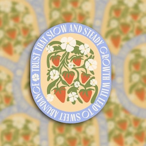 May include: Oval sticker with a light blue border and a cream-colored center. The center features a strawberry plant with red strawberries, white flowers, and green leaves. Text around the border reads: "TRUST THAT SLOW AND STEADY GROWTH WILL LEAD TO SWEET ABUNDANCE."