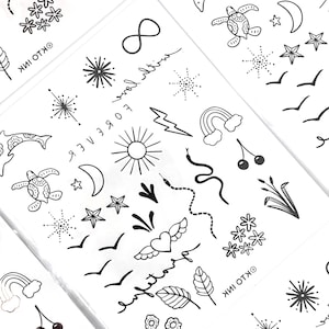 May include: A sheet of temporary tattoos with various designs, including a turtle, a dolphin, a snake, a heart with wings, a sun, a rainbow, a crescent moon, a star, a lightning bolt, an infinity symbol, and the words "forever wild".