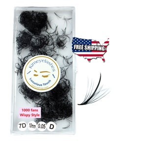 May include: A clear plastic container filled with black wispy eyelash extensions. The container has a label that reads "Kimeyelash Luxurious Touch conicoshop.com 1000 fans Wispy Style 7D 10mm 0.05 D".