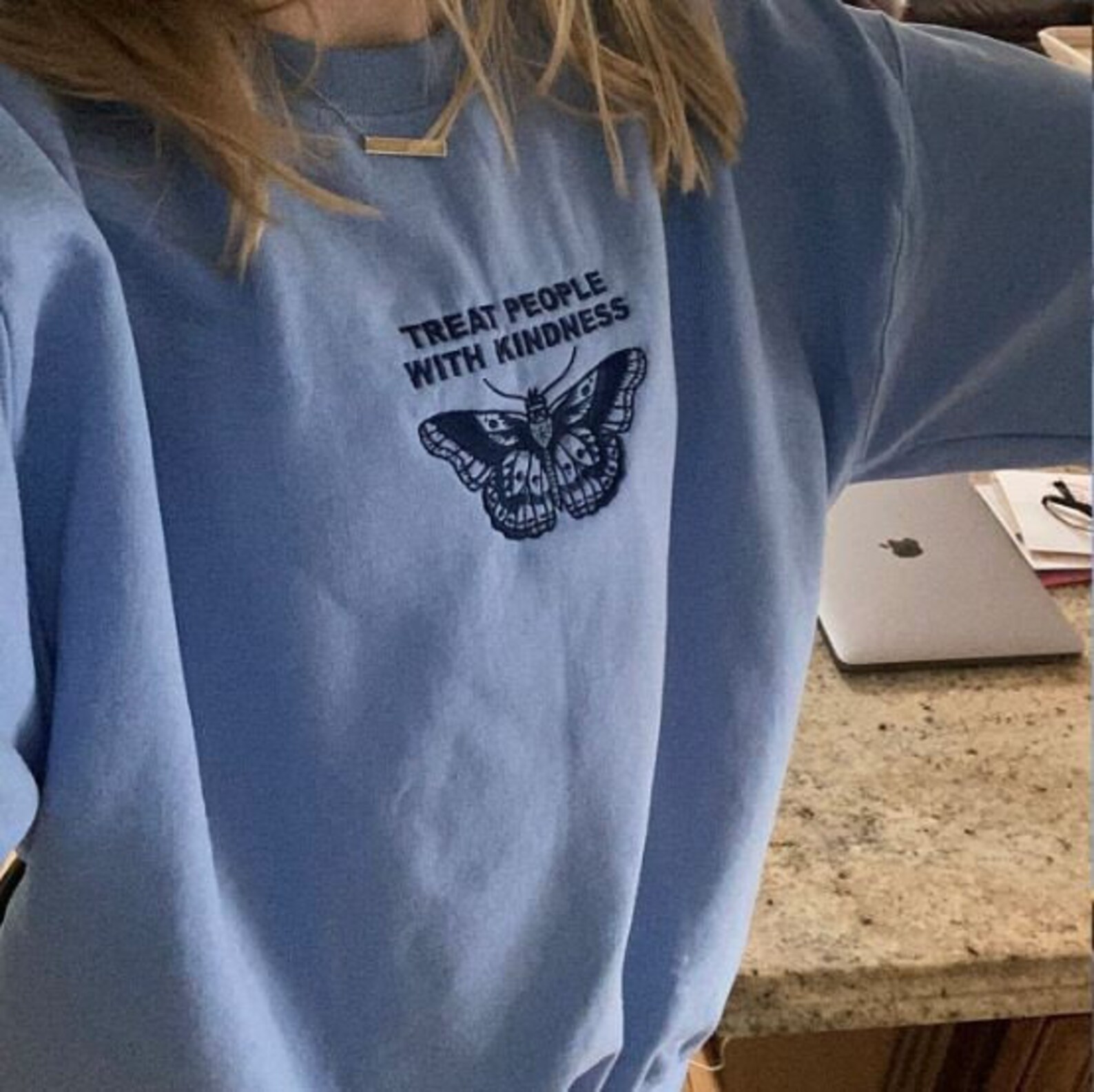 white sweater with blue butterfly