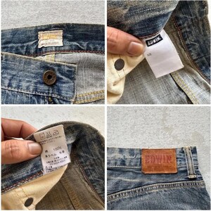 May include: Detailed shots of blue denim jeans, highlighting the button, labels, and leather patch. The jeans have a worn appearance, with visible stitching and the brand name "Edwin" on the tags and patch.