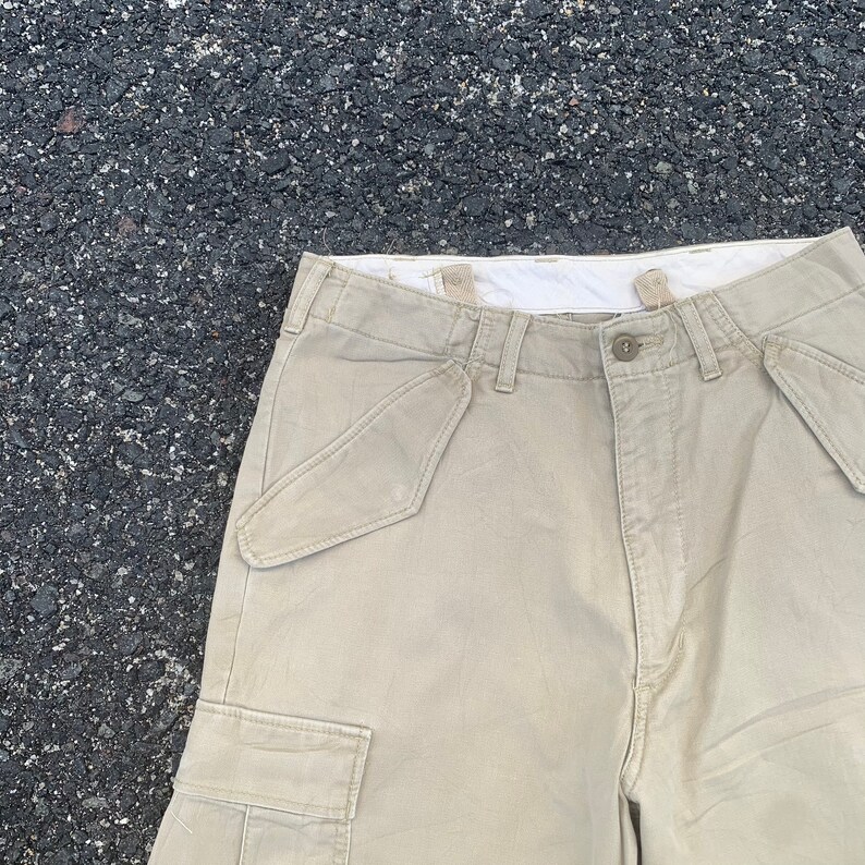 May include: A set of three ceramic mugs with a speckled, matte finish. The mugs are in shades of cream, light gray, and dark gray. Each mug has a simple, modern design and a rounded handle. Perfect for coffee or tea.