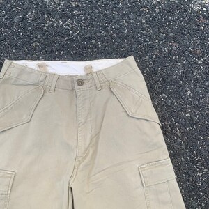 May include: A set of three ceramic mugs with a speckled, matte finish. The mugs are in shades of cream, light gray, and dark gray. Each mug has a simple, minimalist design and a rounded handle. Perfect for coffee or tea.