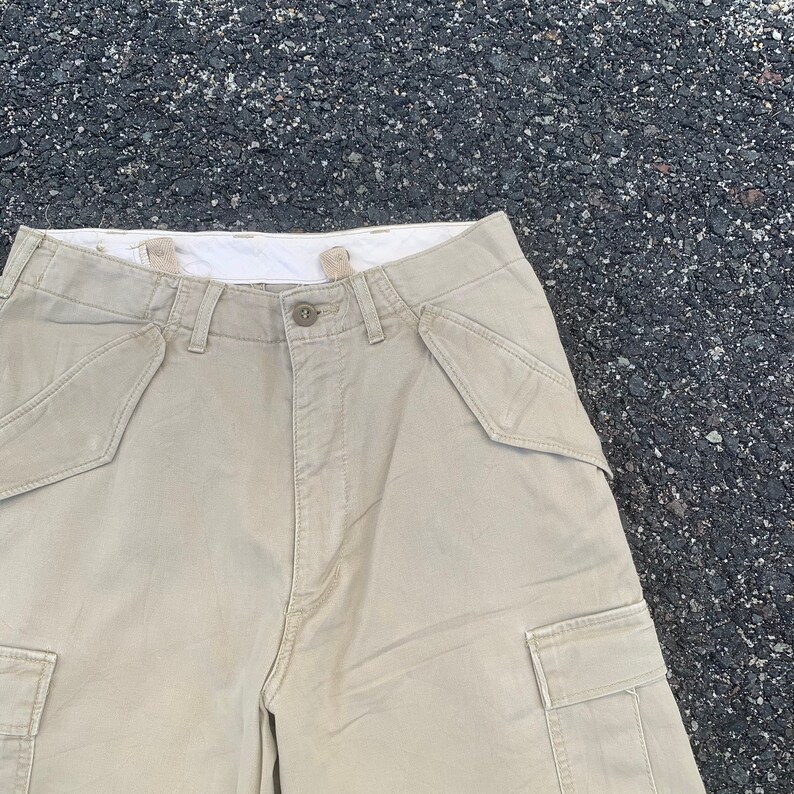 May include: A set of three ceramic mugs with a speckled, matte finish. The mugs are in shades of cream, light gray, and dark gray. Each mug has a simple, minimalist design and a rounded handle. Perfect for coffee or tea.