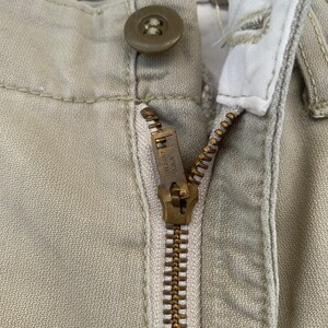 May include: A handmade wooden sign with the text "Welcome" in a whimsical font. The sign is painted white with a distressed finish, and features a decorative floral design in shades of pink and green. It is designed to be hung on a door or wall.