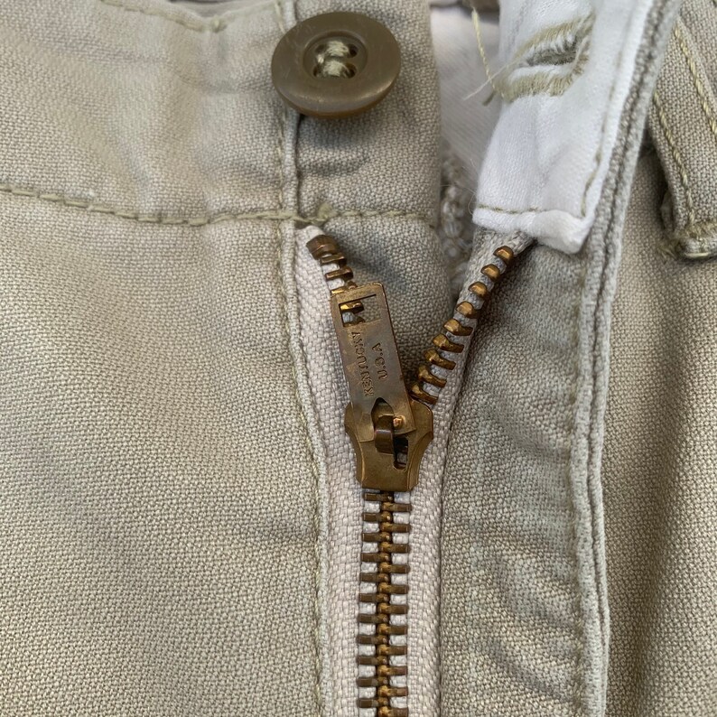 May include: A handmade wooden sign with the text "Welcome" in a whimsical font. The sign is painted white with a distressed finish, and features a decorative floral design in shades of pink and green. It is designed to be hung on a door or wall.