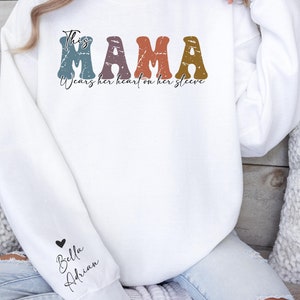 Personalized Mom Sweatshirt With Kids Names, Cute Momma Outfit, Mothers Day Gifts, Custom This Mama Wears Her Heart On Her Sleeve Hoodie