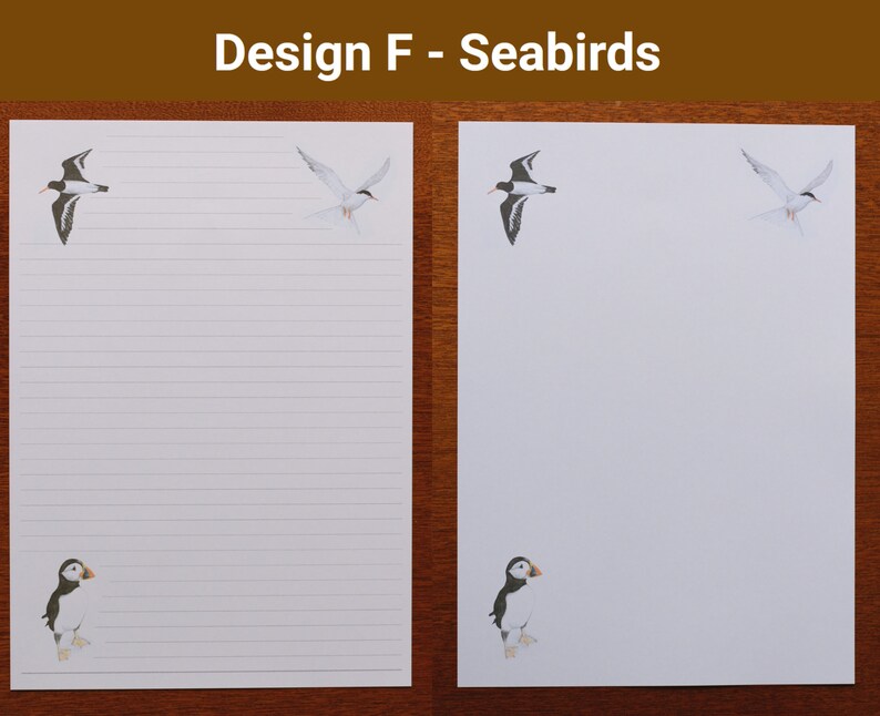 May include: White lined stationery with seabird illustrations. The design includes a puffin, a tern, and another seabird. The text "Design F - Seabirds" is at the top. The stationery is on a wooden surface.