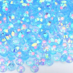 May include: A large quantity of small, iridescent, light blue, round, flat-backed rhinestones.