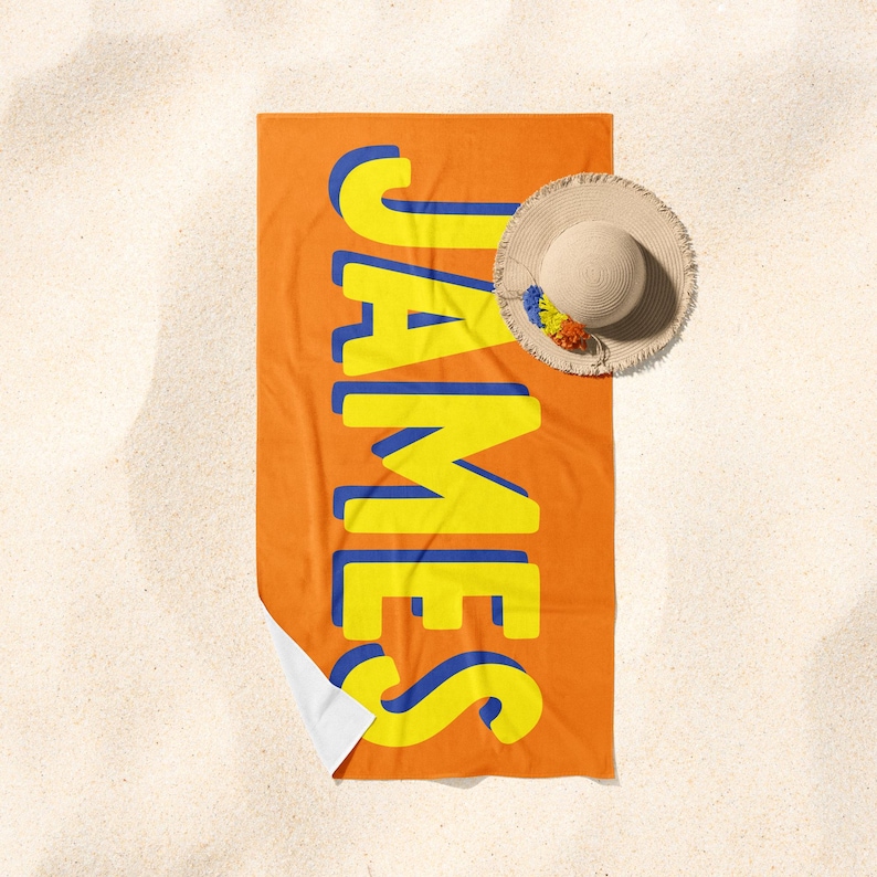 May include: Orange beach towel with the name "JAMES" in large yellow letters with blue outlines.