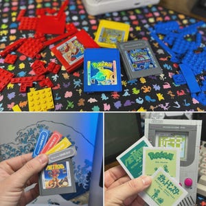 May include: A selection of retro video game cartridges, including Pokemon and Metroid, and colourful Lego bricks. The cartridges are in various colours, including blue, yellow, and grey. The background features a patterned fabric with various shapes and colours.