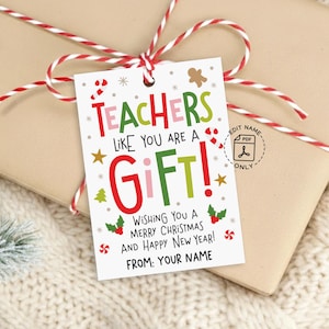 May include: A gift tag with the message "Teachers like you are a gift!" in red, green, and pink, decorated with Christmas-themed graphics. The tag is tied to a wrapped gift with red and white twine.