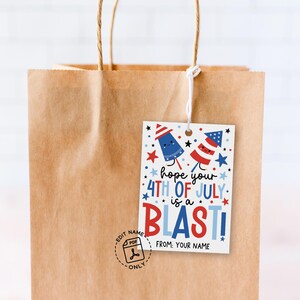 Flat lay of printable tag with fun fireworks and stars in red, white and blue, perfect for adding to 4th of July treat bags and holiday gifts