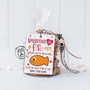 Fun fish-themed valentine tag printable displaying the words “You are o-fish-ally awesome” above a pink polka dot fish illustration, with “Happy Valentine’s Day” and name line below, meant to be printed, cut, and attached to classroom gift bags or goodie sacks.