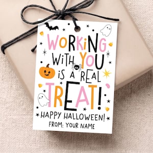 May include: A rectangular white gift tag featuring the text "WORKING WITH YOU IS A REAL TREAT! HAPPY HALLOWEEN! FROM: YOUR NAME" in black, pink, and orange. The design includes illustrations of a pumpkin, a spider, two ghosts, a bat, and candy corn.