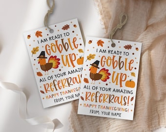 May include: Two Thanksgiving-themed gift tags with a turkey illustration wearing a pilgrim hat. The tags read "I am ready to gobble up all of your amazing referrals! Happy Thanksgiving!" with space for a name.