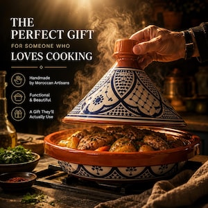May include: A terracotta tagine with a conical lid featuring blue and white geometric patterns. The base contains cooked meat and vegetables. Text on the image reads: THE PERFECT GIFT FOR SOMEONE WHO LOVES COOKING, Handmade by Moroccan Artisans.